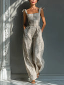 Tuta a gamba larga in misto lino beige a righe con spalle annodate