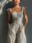 Tuta a gamba larga in misto lino beige a righe con spalle annodate
