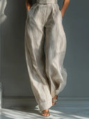 Tuta a gamba larga in misto lino beige a righe con spalle annodate