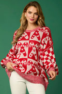 Maglione lavorato a maglia con bastoncini di zucchero di Natale e omino di pan di zenzero